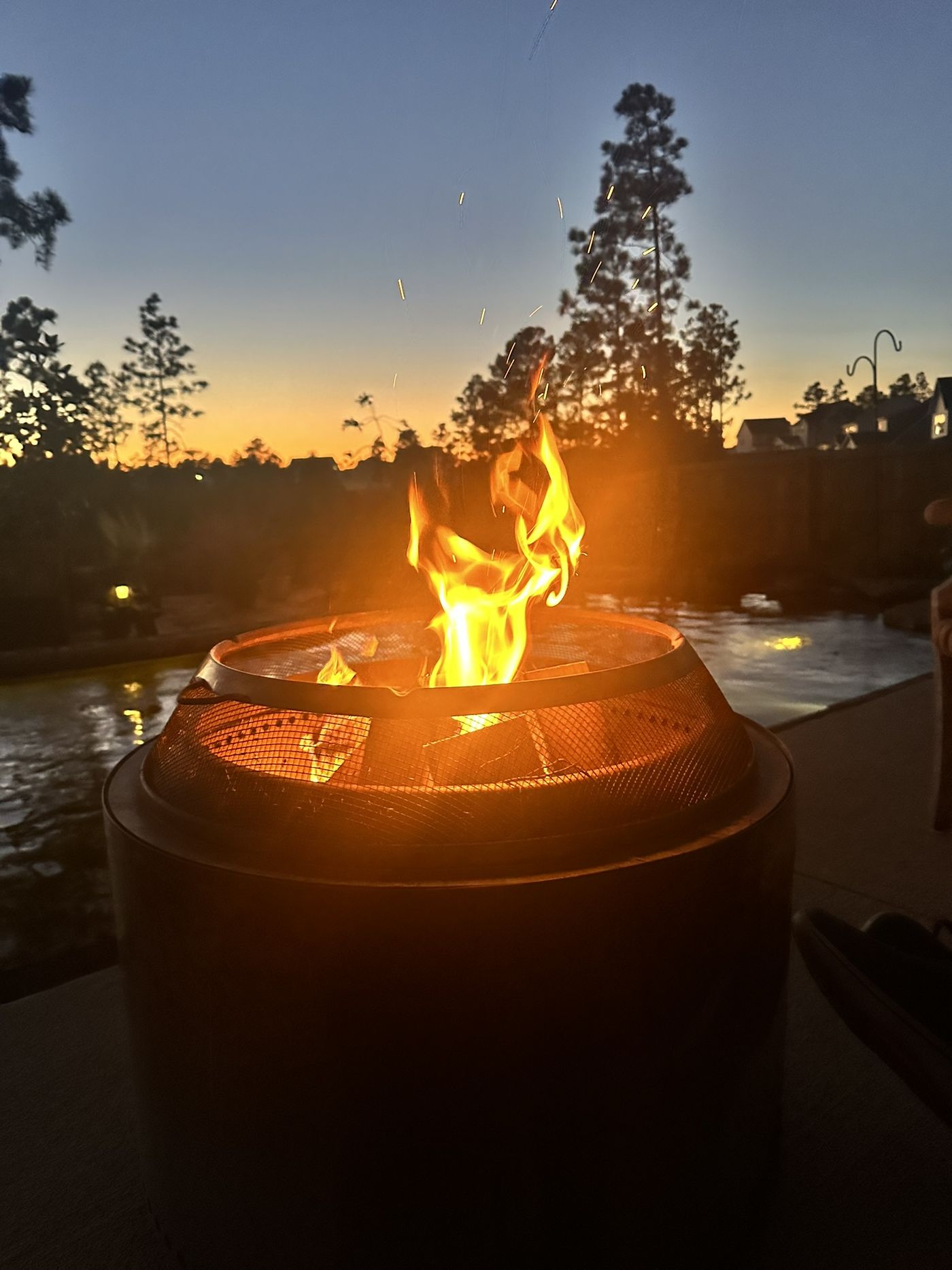 Fire feature by the pond at dusk