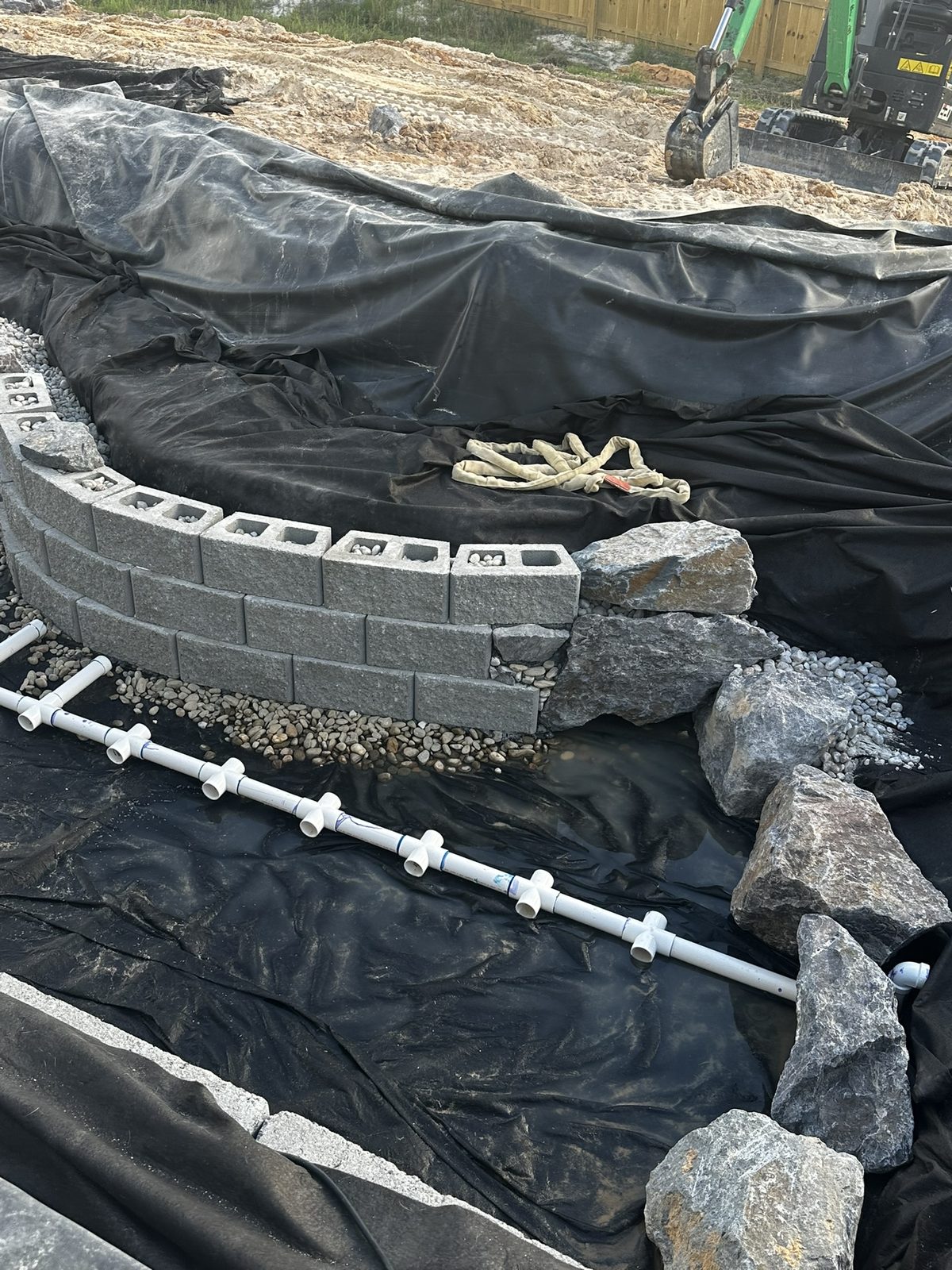 Excavated and lined pond with retaining walls