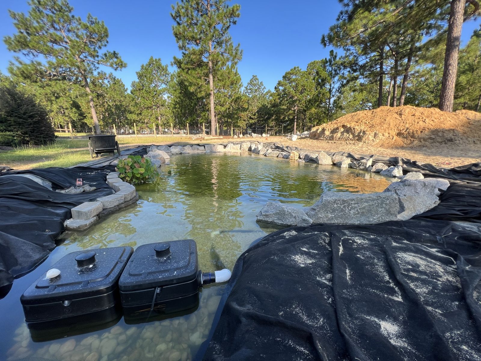 Wide recreation pond with boulder edge